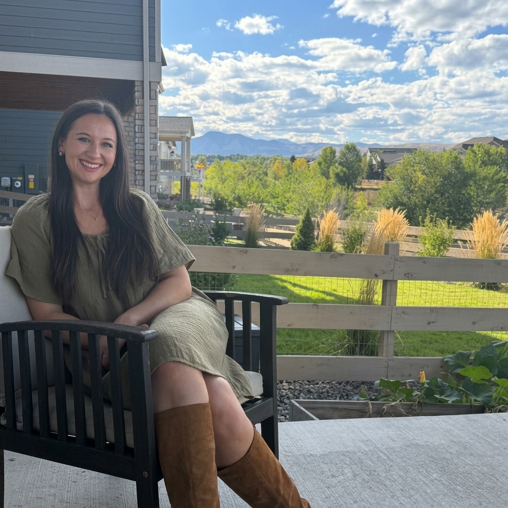 Rachel Connell sitting outside with mountains in the background